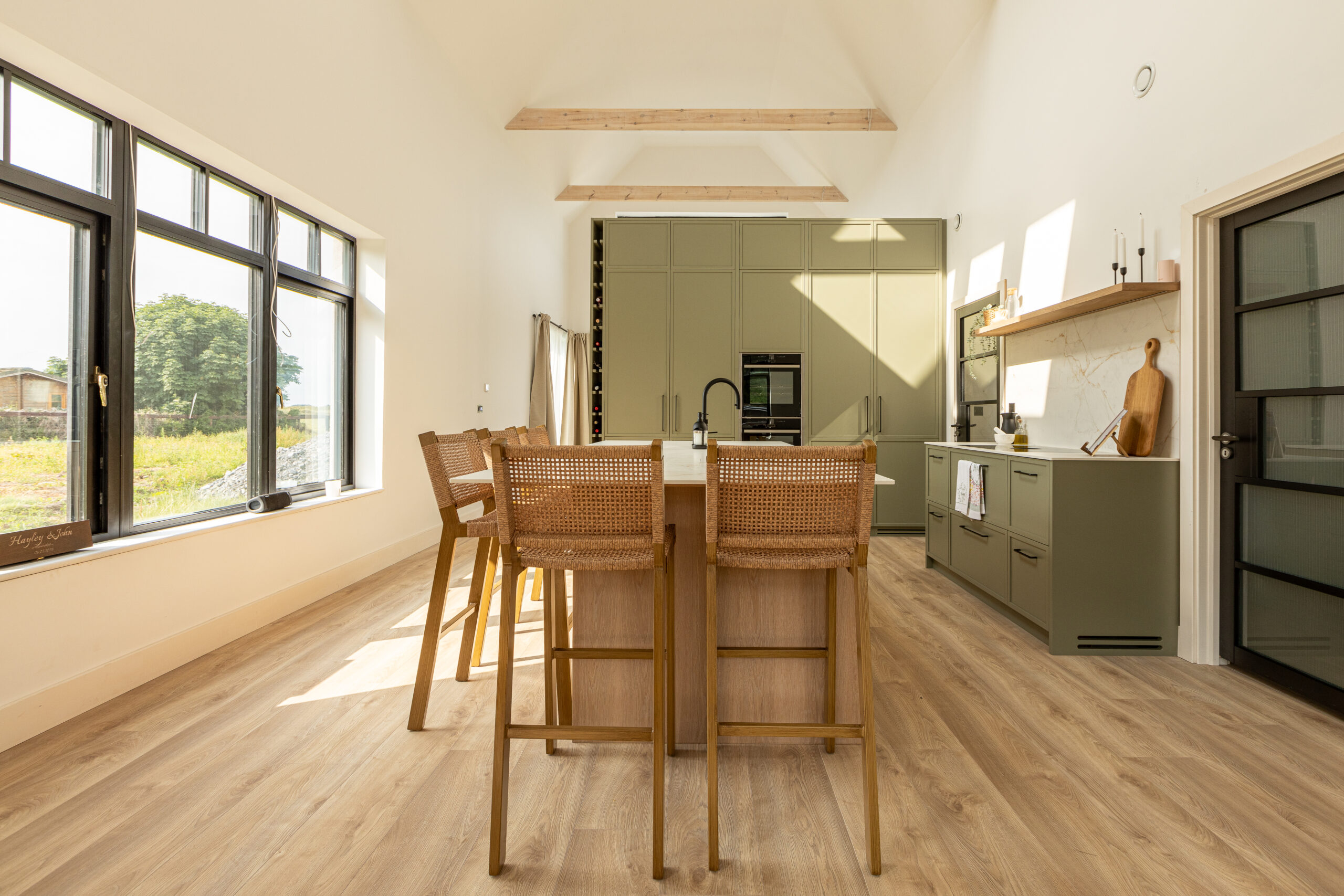 A refined modern classic kitchen combining timeless shaker cabinetry with contemporary finishes and natural warmth.