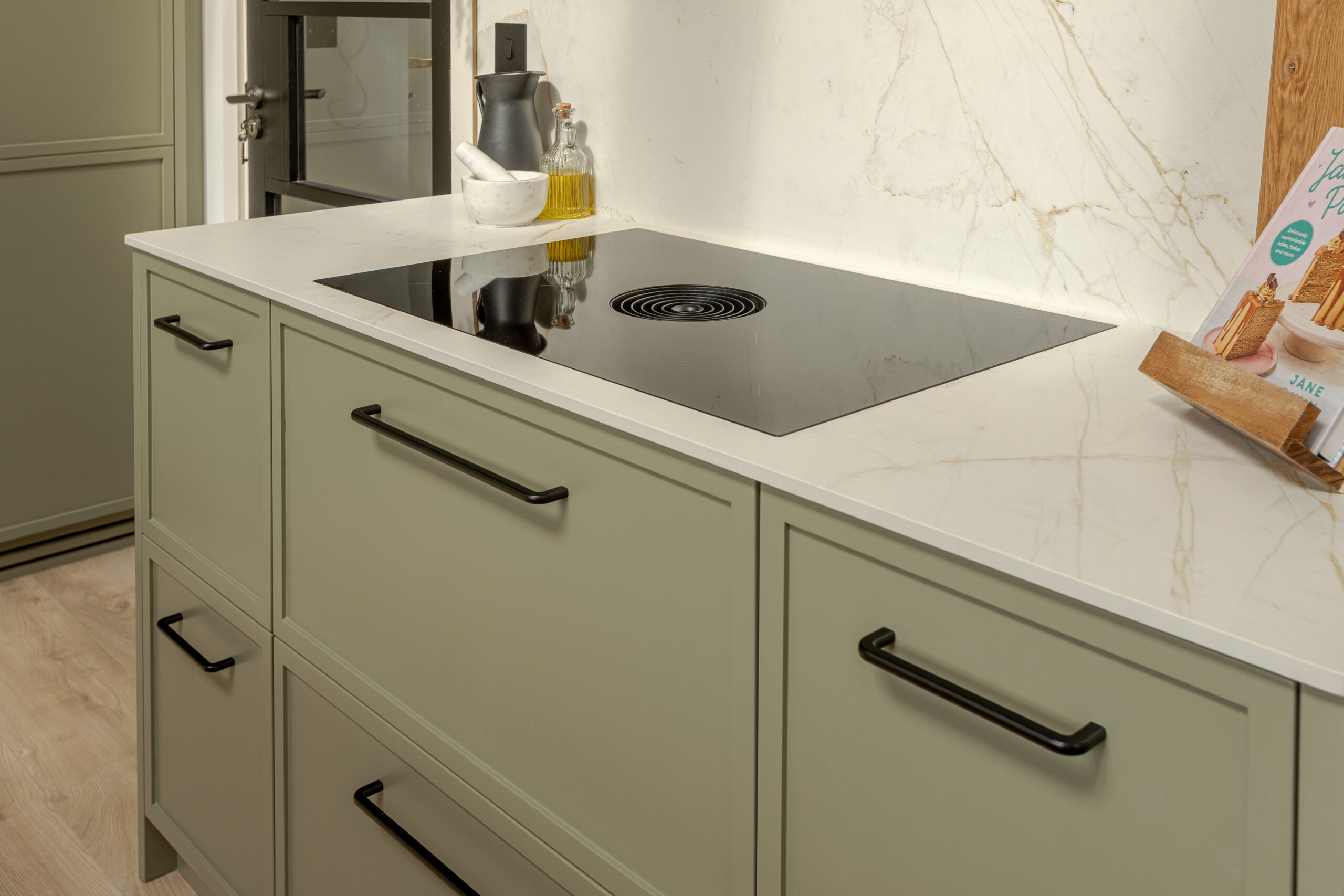 A refined modern classic kitchen combining timeless shaker cabinetry with contemporary finishes and natural warmth.