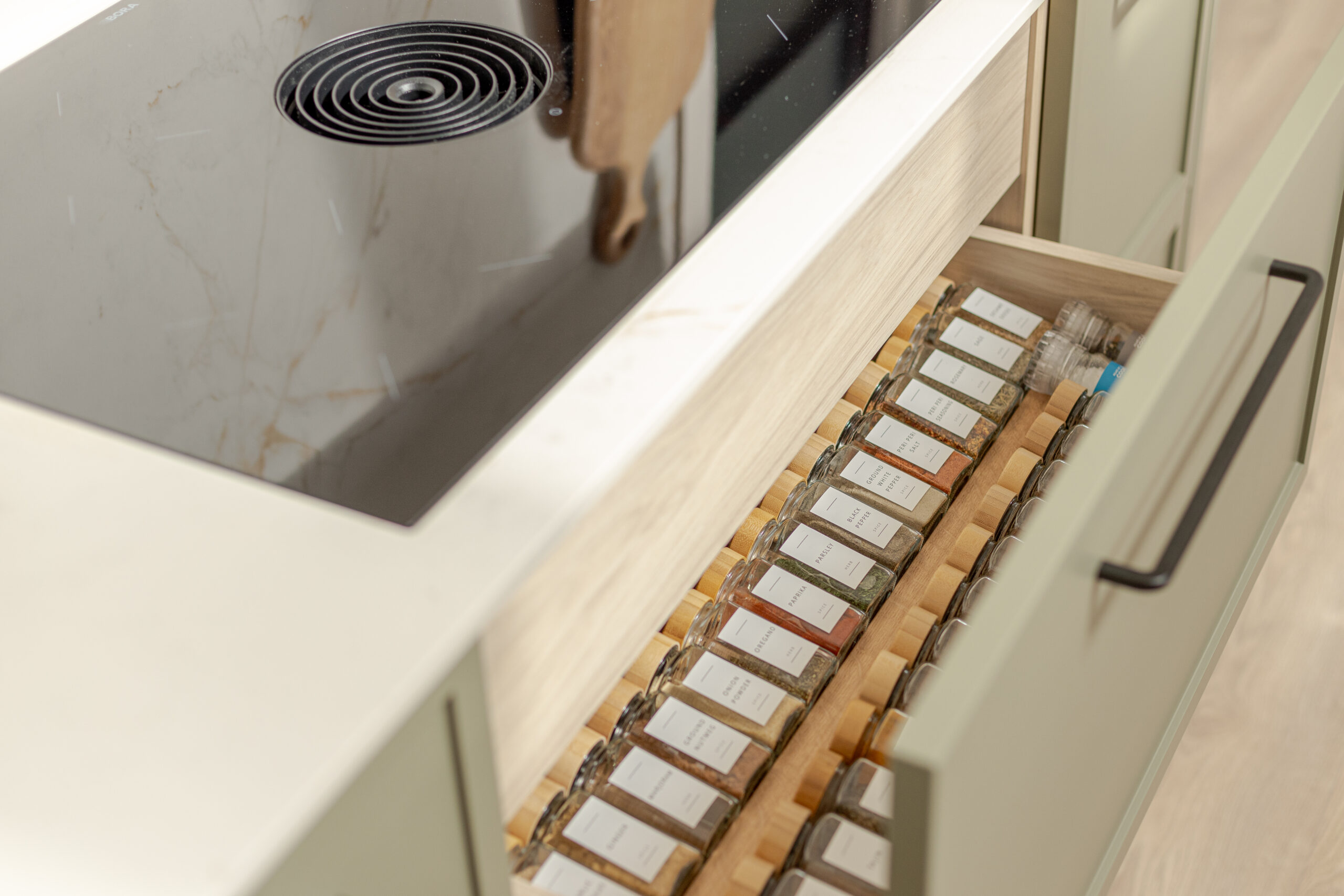 A refined modern classic kitchen combining timeless shaker cabinetry with contemporary finishes and natural warmth.