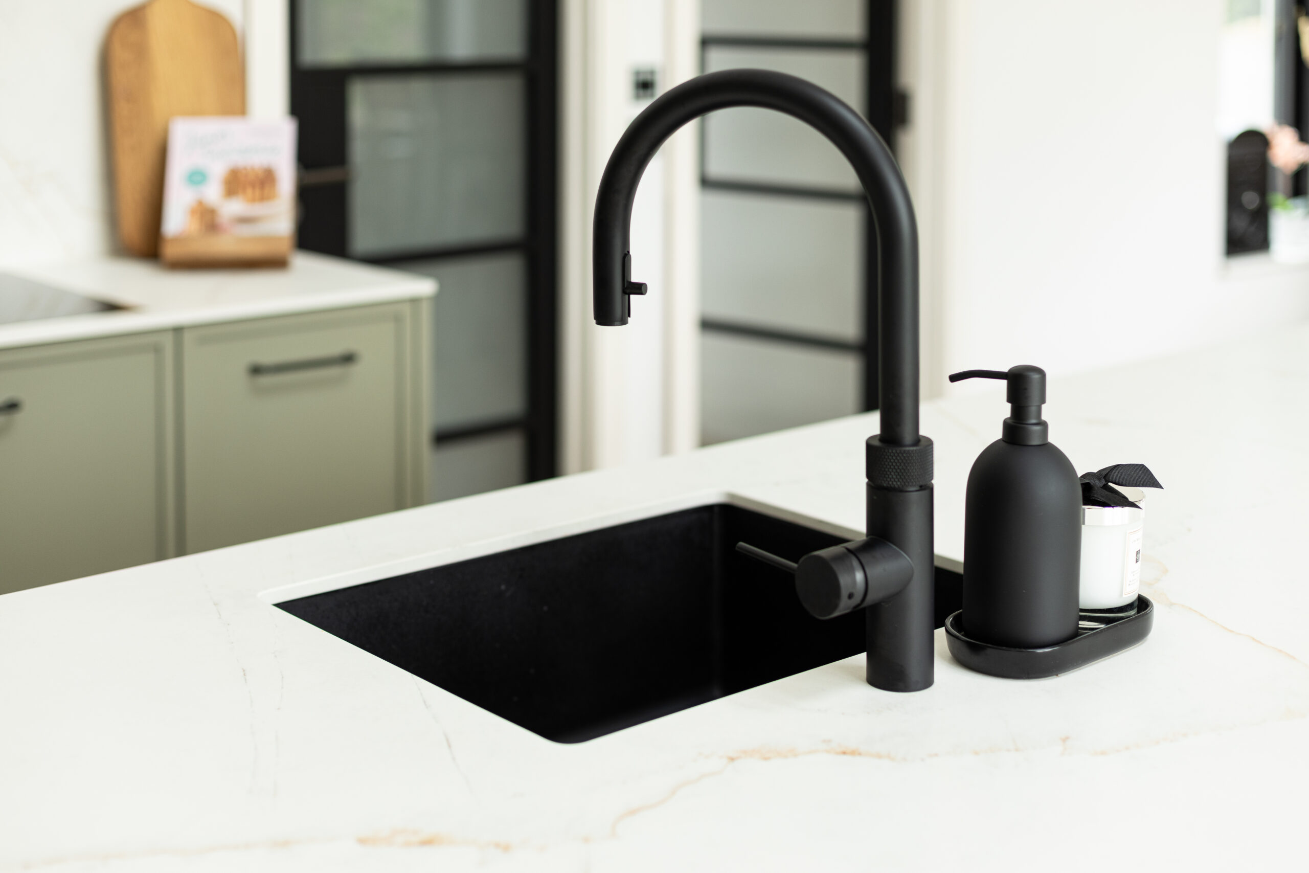 A refined modern classic kitchen combining timeless shaker cabinetry with contemporary finishes and natural warmth.